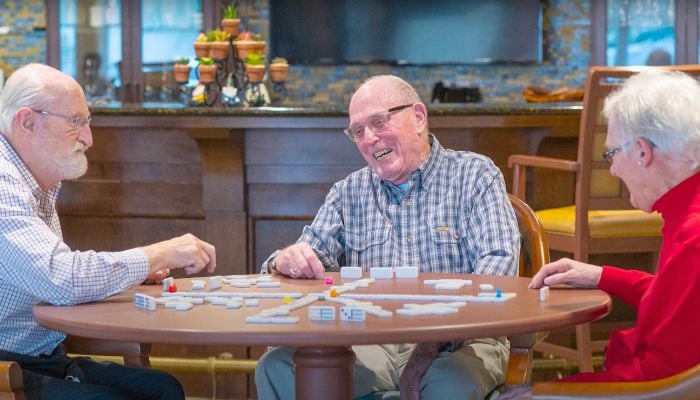 Otterbein Sunset Village Residents playing a game together in the clubhouse.