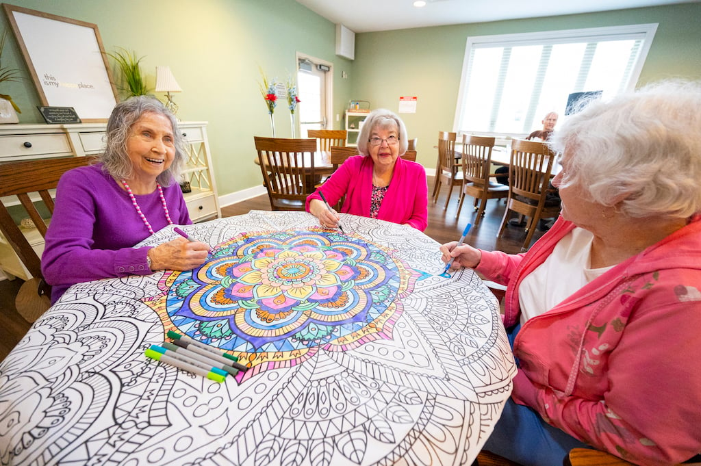 Residents coloring at a table together at Otterbein Cridersville.