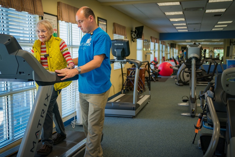 Resident on a treadmill with therapist