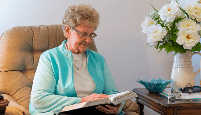 Senior woman enjoying her time reading a book