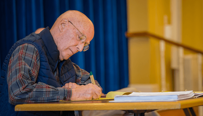 Senior man writing a memoir.