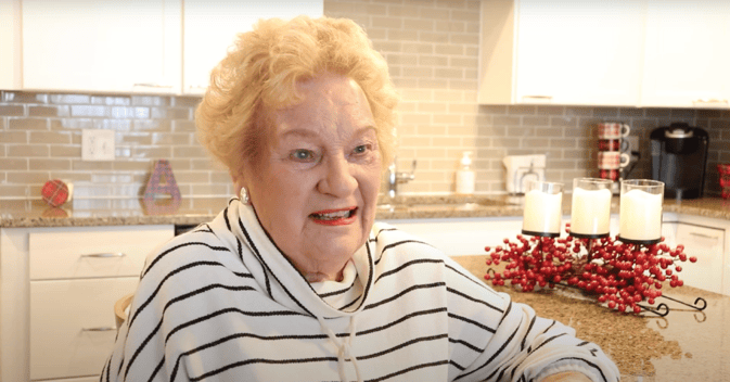 Otterbein Lebanon resident Beverly A. smiling sitting at an island in her kitchen.