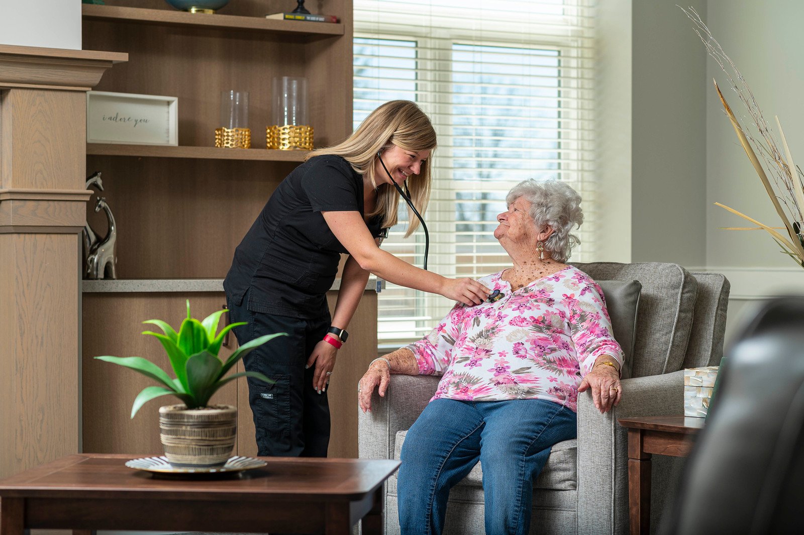 Home health care nurse listens to a senior woman's heart beat during an Otterbein SeniorLife home health visit