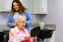 Otterbein SeniorLife resident getting a haircut in the campus salon.