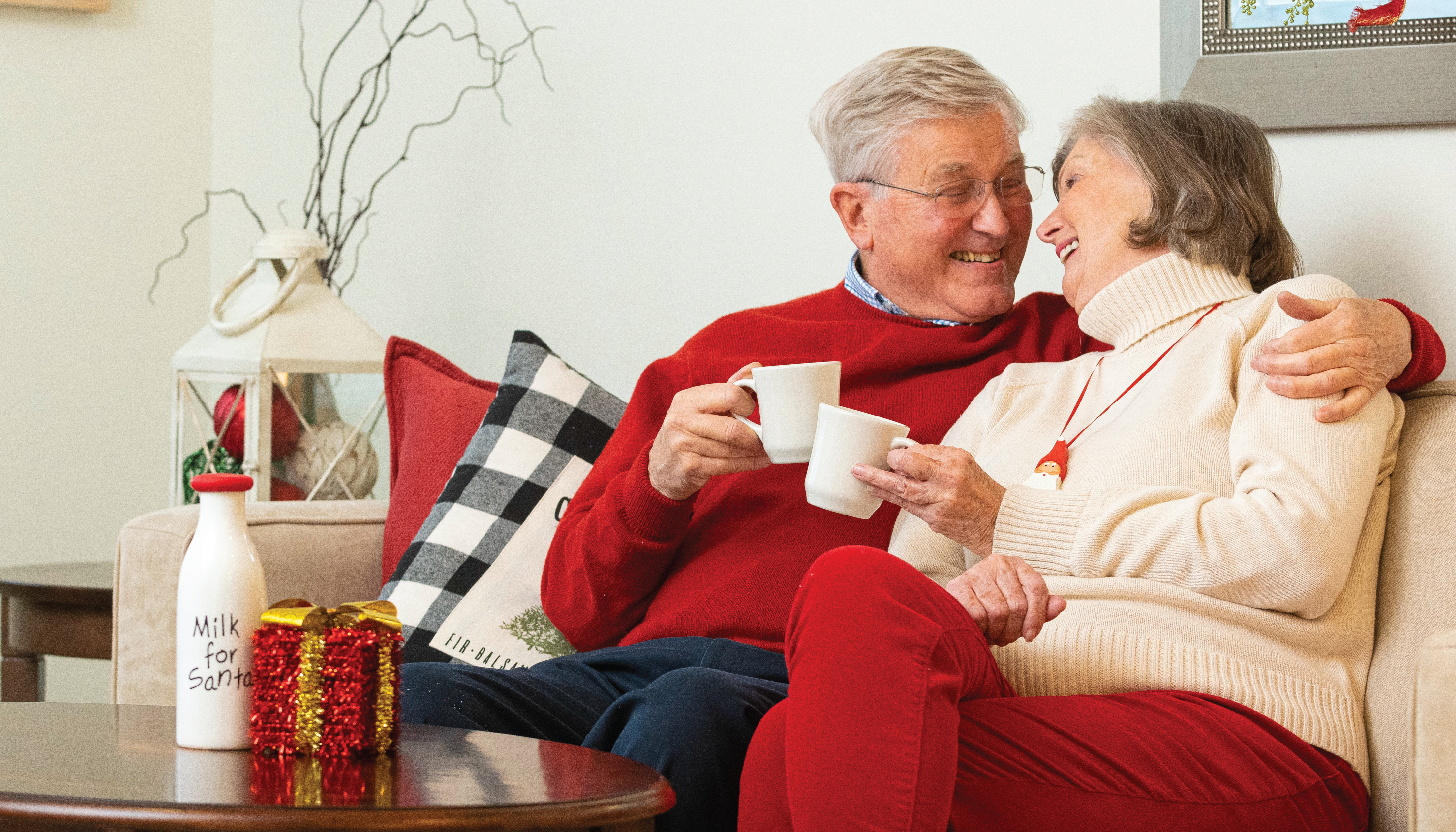 Independent living couple at Otterbein SeniorLife relax on the couch at home during winter