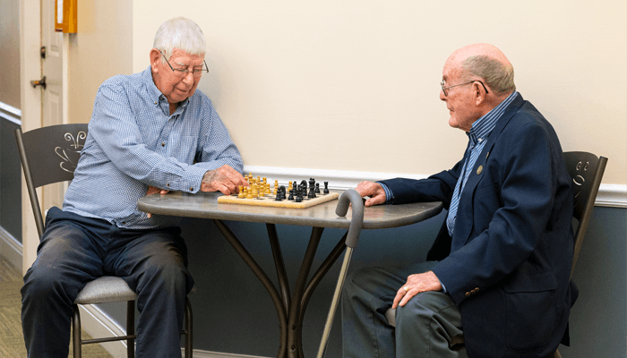 Senior men enjoying a game of chess.