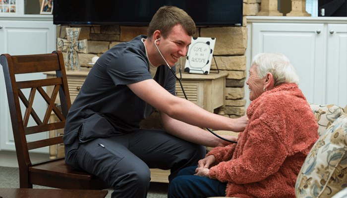 Otterbein SeniorLife staff member checking a resident’s heartbeat.