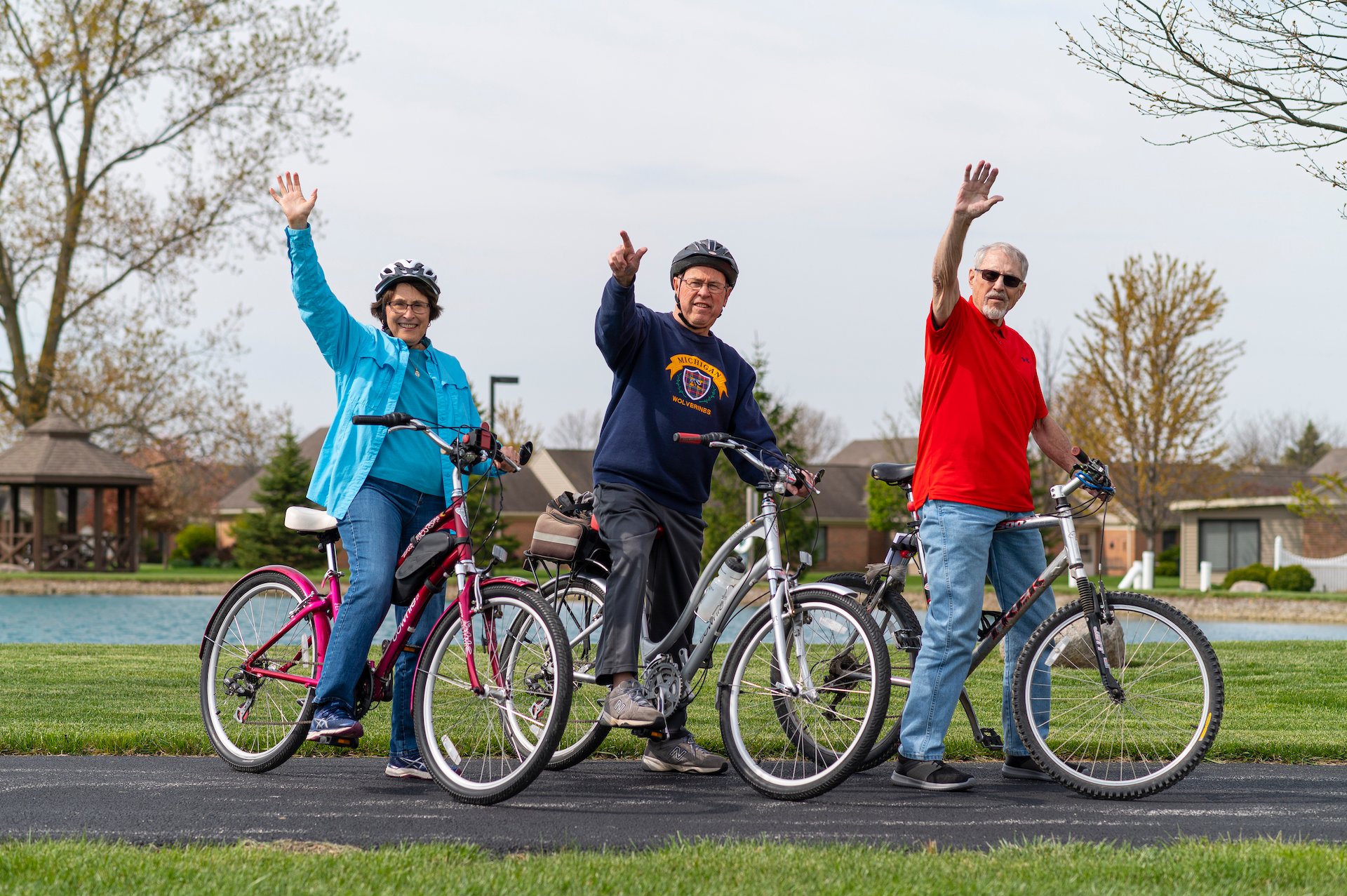 Otterbein Pemberville residents on their bikes waving and smiling.