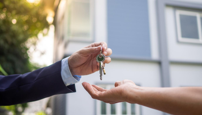  Home seller handing keys to real estate agent 