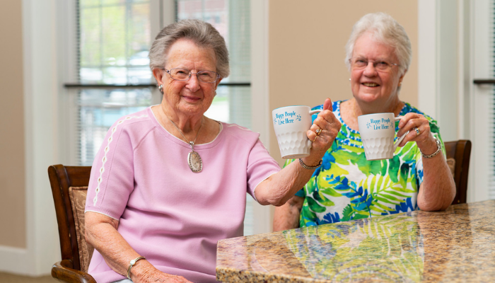 Two senior women sitting in an Otterbein Lebanon kitchen in the spring doing spring cleaning