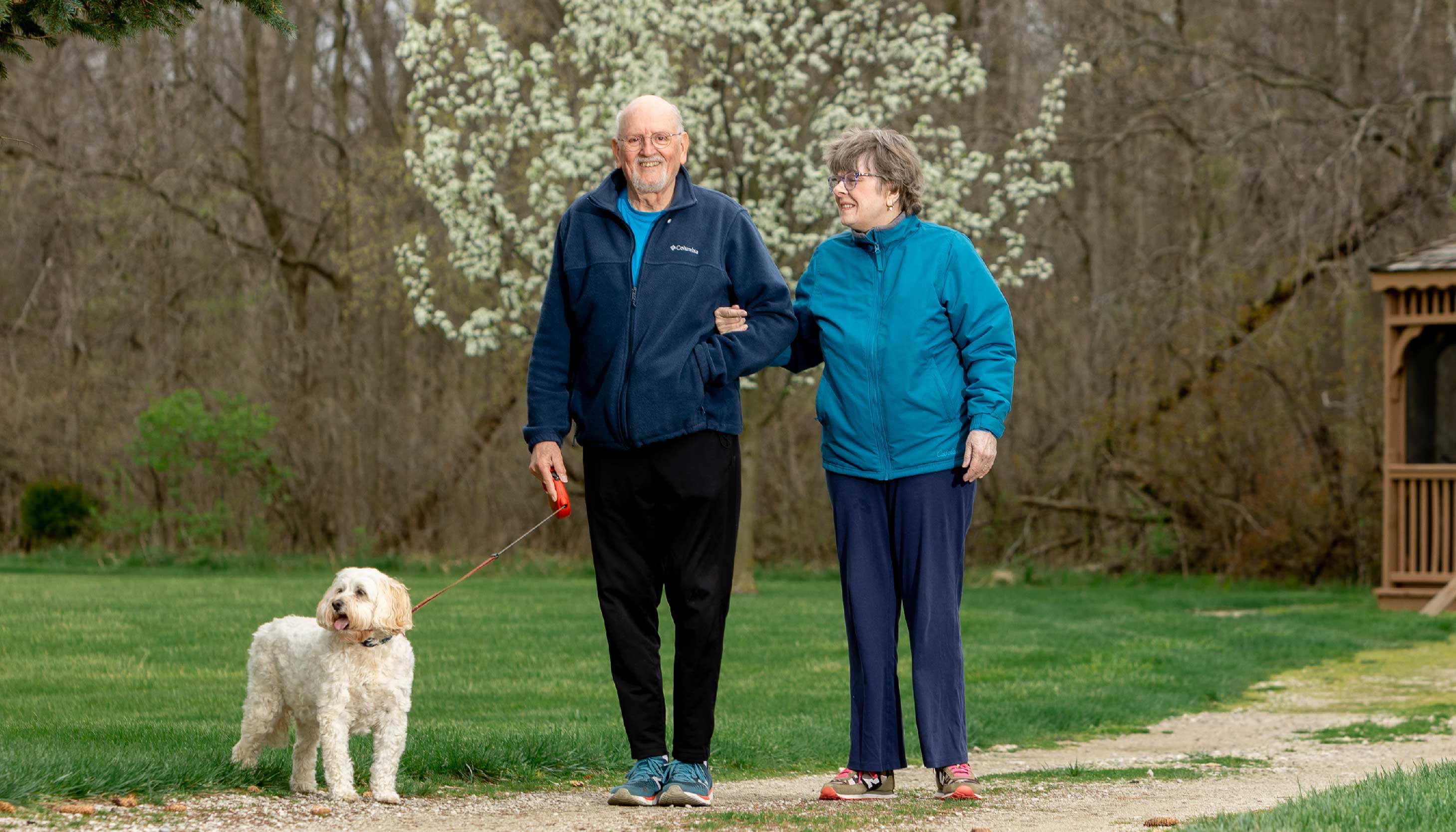 Otterbein SeniorLife residents Jim and Carolyn R. walking their dog
