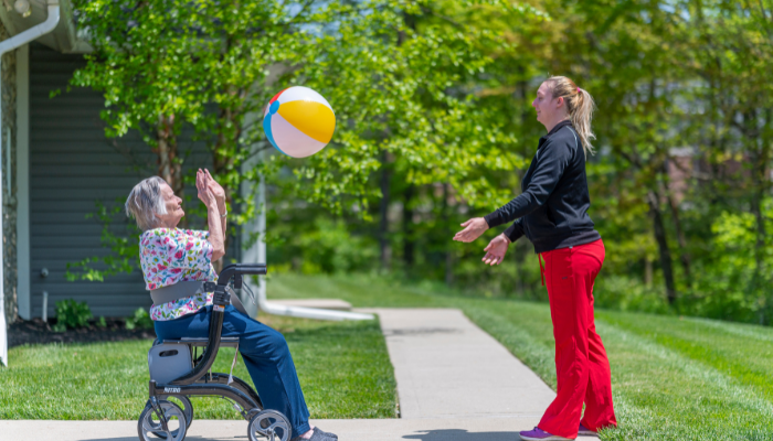 Otterbein SeniorLife Resident and one of our partners playing with a beach ball. 