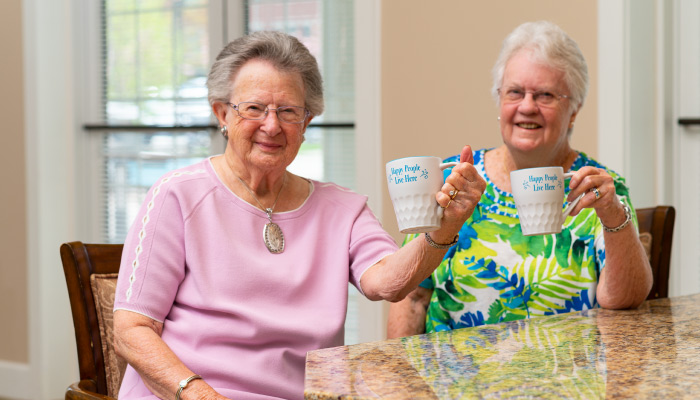 Otterbein residents raising mugs in the air. 